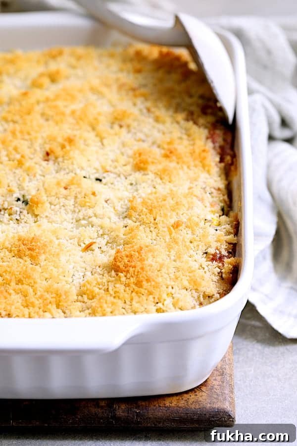Photo of Zucchini, Yellow Squash and Quinoa Casserole in white baking dish before being served.