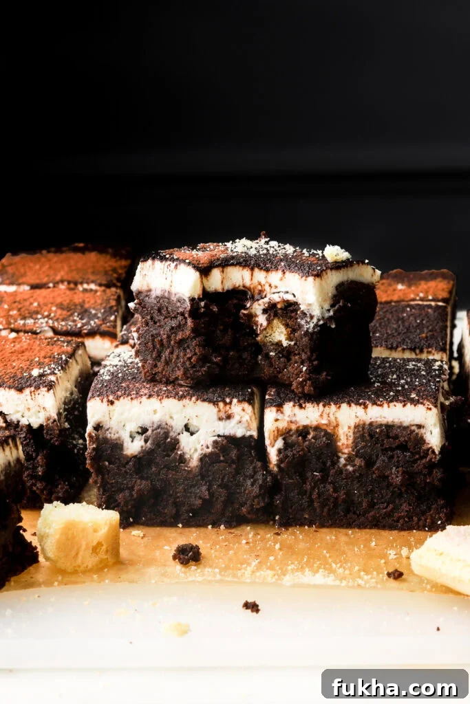 tiramisu brownies sliced and stacked with a bite taken out