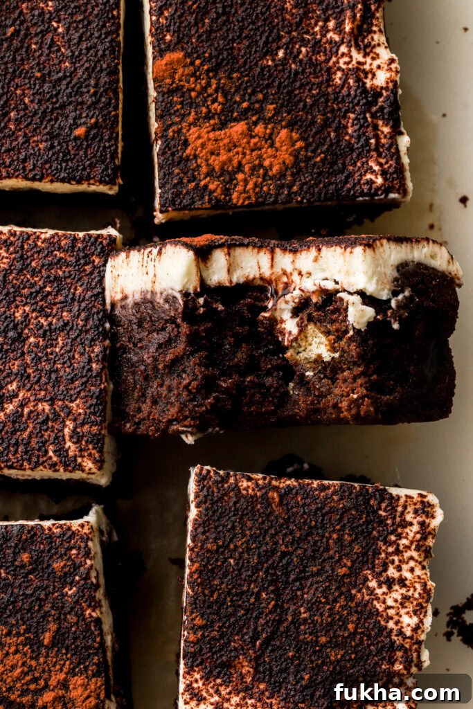 close up of tiramisu brownies sliced and a bite taken out