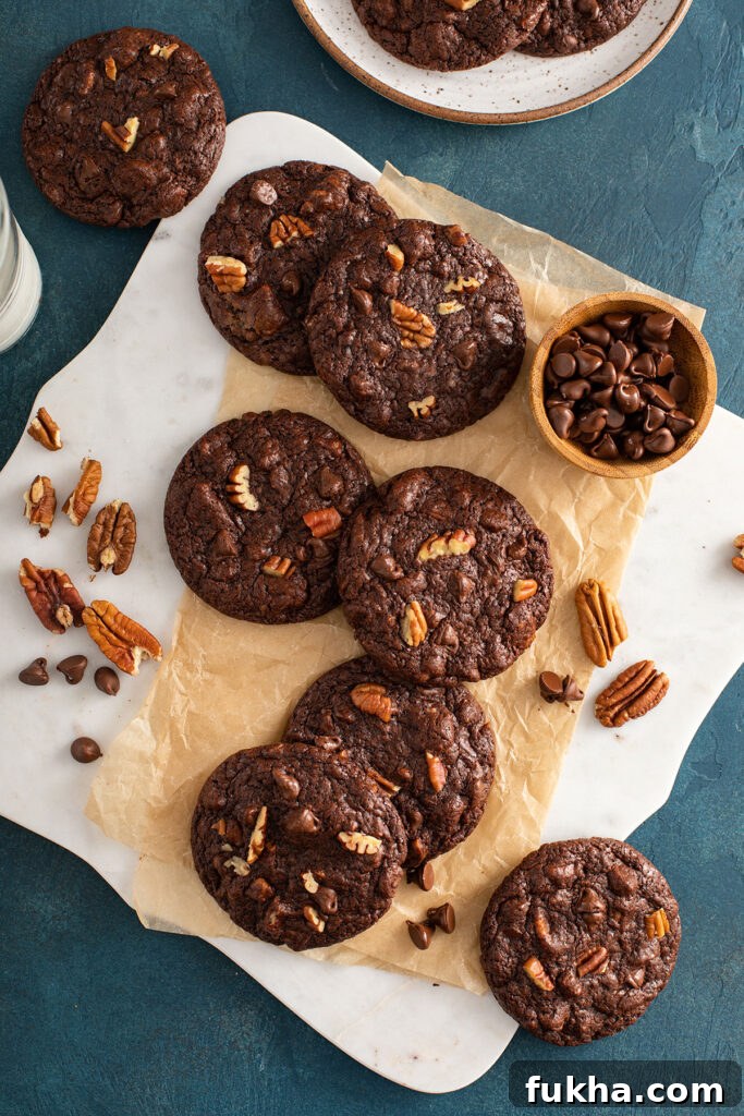 Cookies set on a white board with pecans and chocolate chips