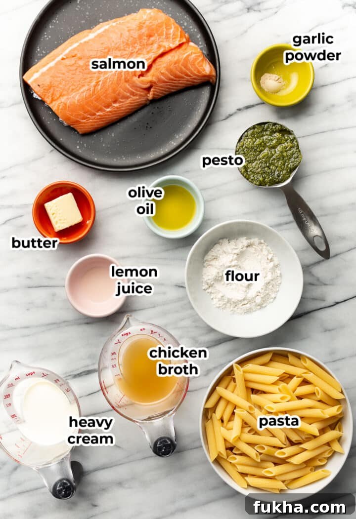 ingredients for salmon pesto pasta in prep bowls and measuring cups