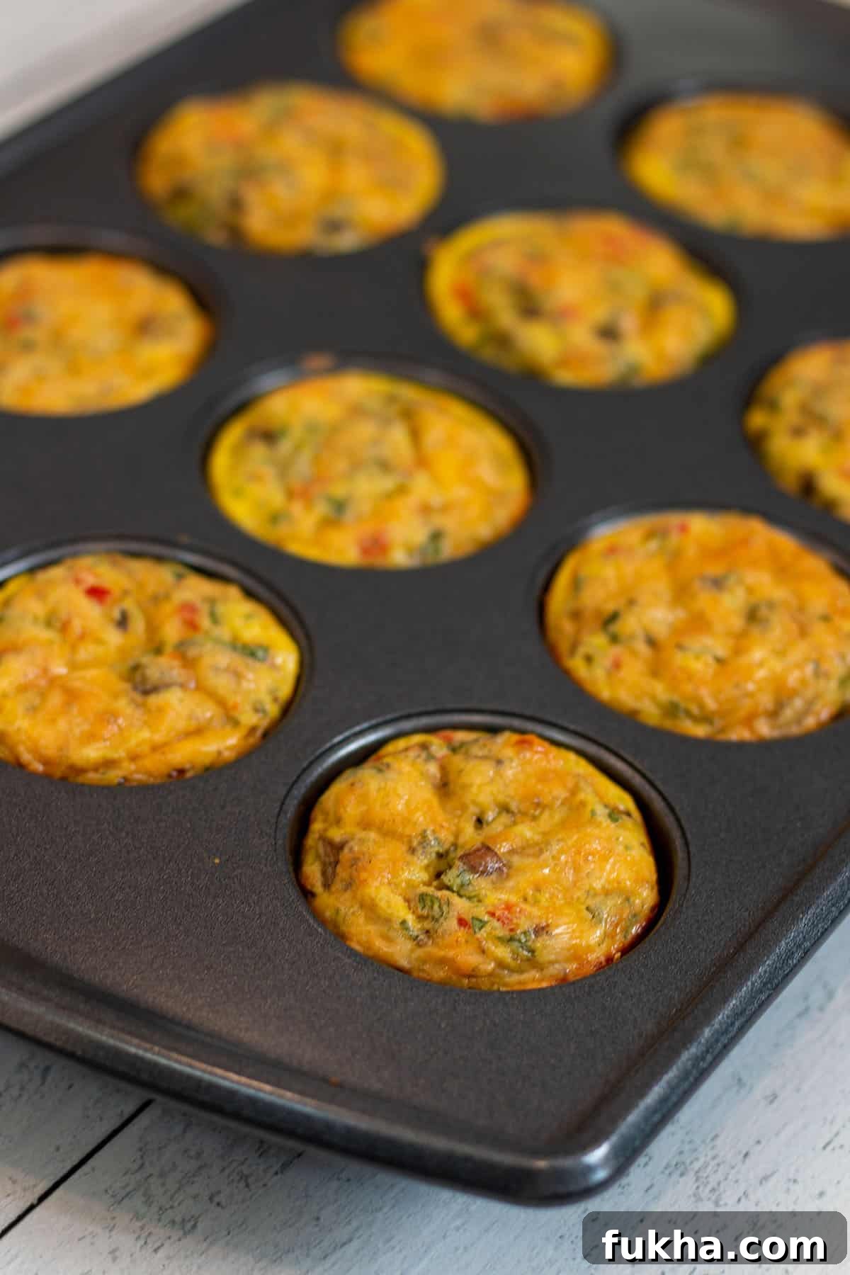 Sourdough Starter Breakfast Bites Recipe 8 Sourdough breakfast bites freshly baked in a 12-muffin pan.