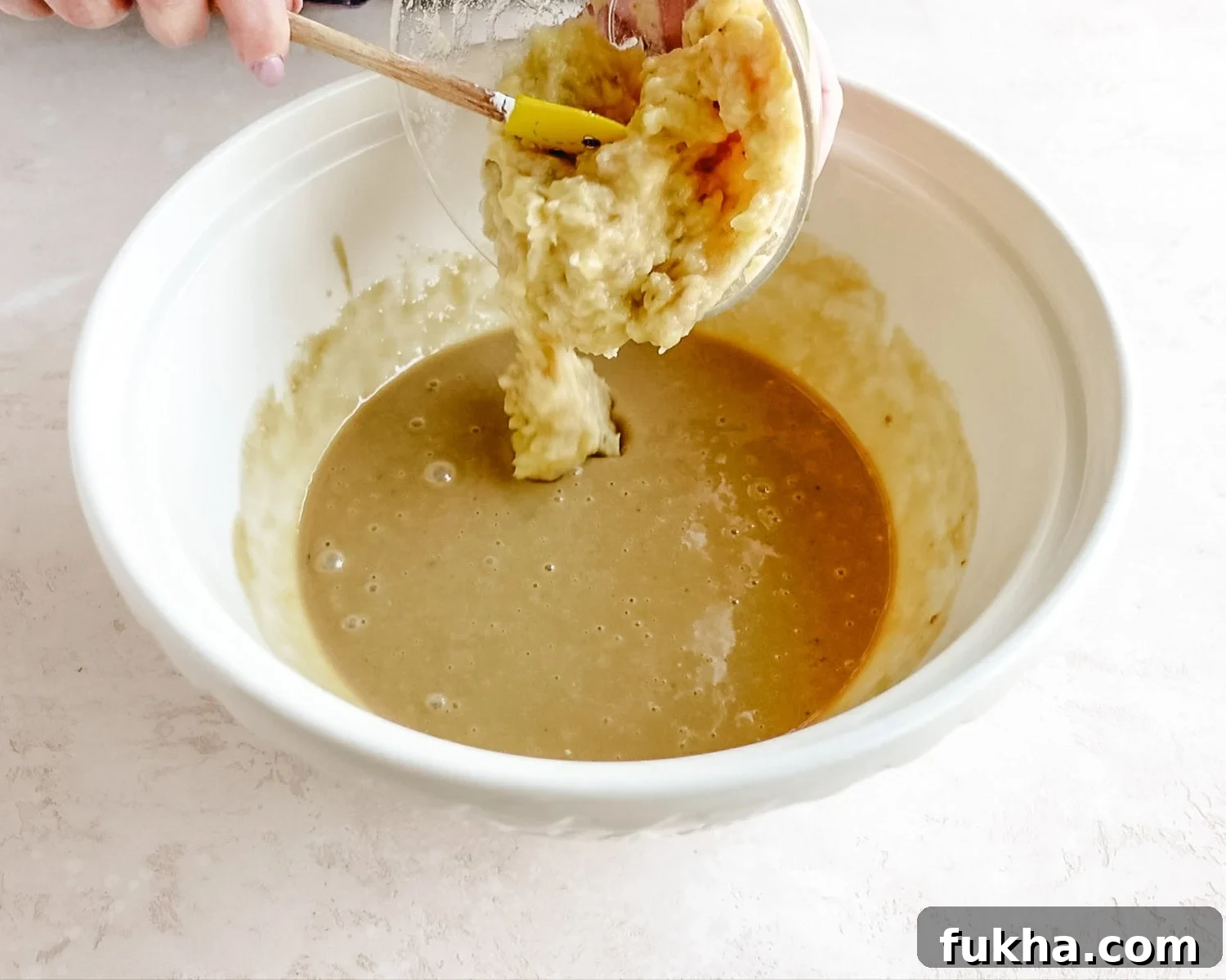 Add mashed banana to the wet ingredients.