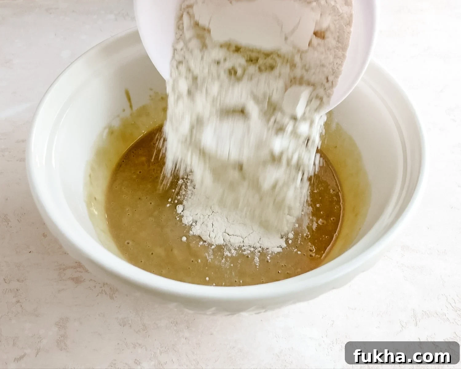 Add flour to the wet ingredients.