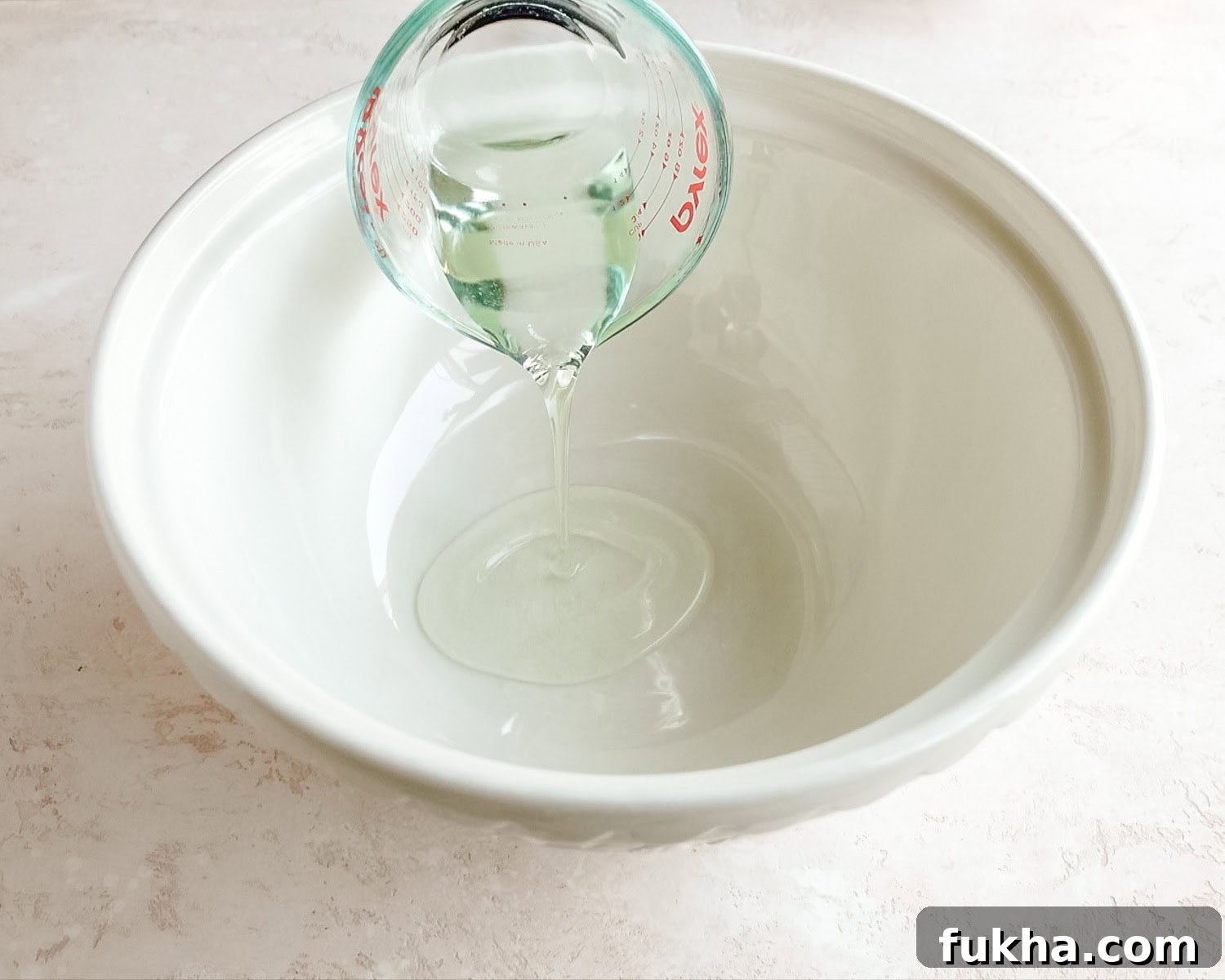 Add vegetable oil to a large mixing bowl.