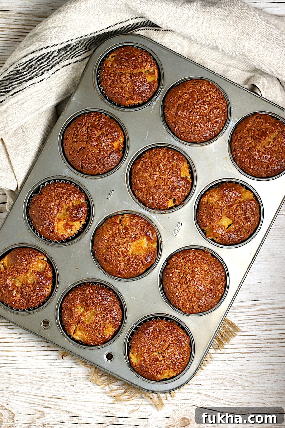 An overhead photo of Peaches and Cream Oatmeal Muffins in a muffin pan.