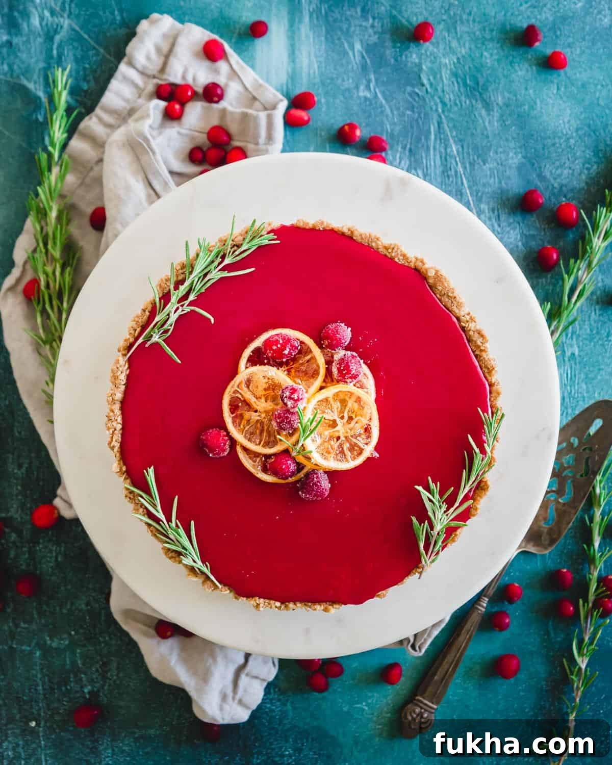 This cranberry curd tart makes a beautifully festive gluten-free holiday dessert with smooth sweet and tart cranberry curd filling and an easy oat and walnut based crust.