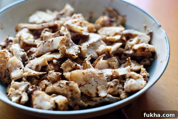 pieces of cooked whitefish in a blue and white bowl