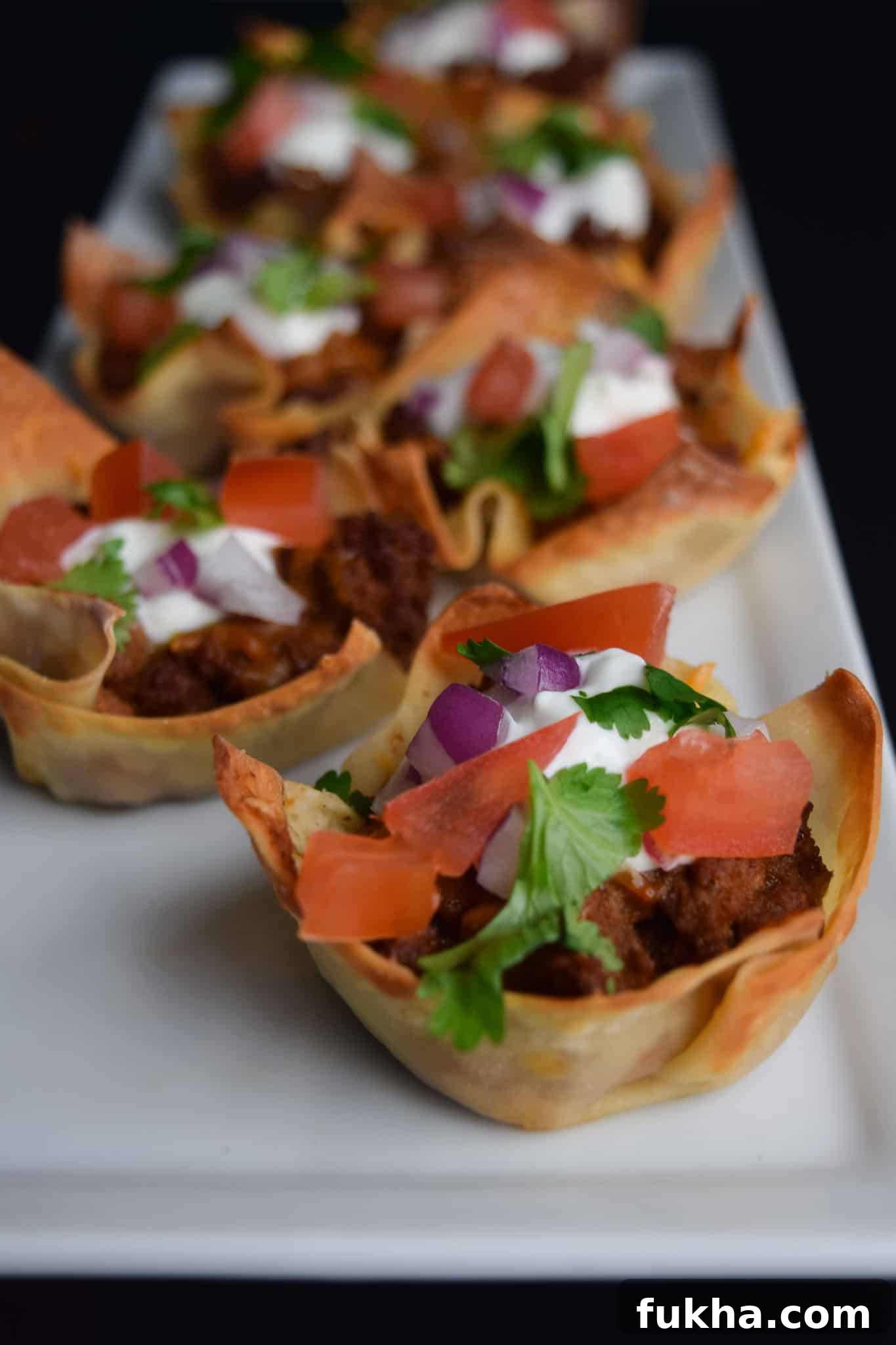 Taco Wonton Cups Recipe for Parties 4 taco won ton cups on white platter ready to be served
