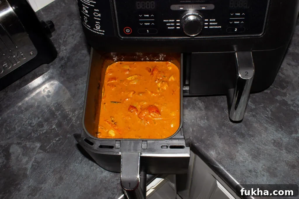 Crispy Air Fryer Chicken Curry in 25 Minutes 6 Fully cooked air fryer chicken curry in the drawer of a Ninja Dual