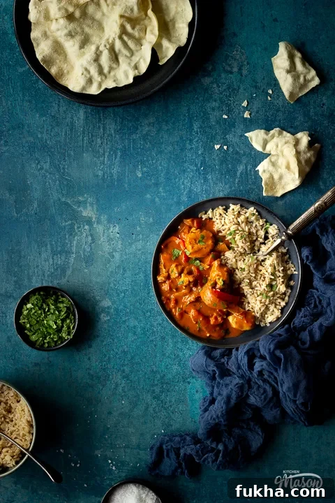 Crispy Air Fryer Chicken Curry in 25 Minutes 3 Air fryer chicken curry and rice on a blue plate with coriander
