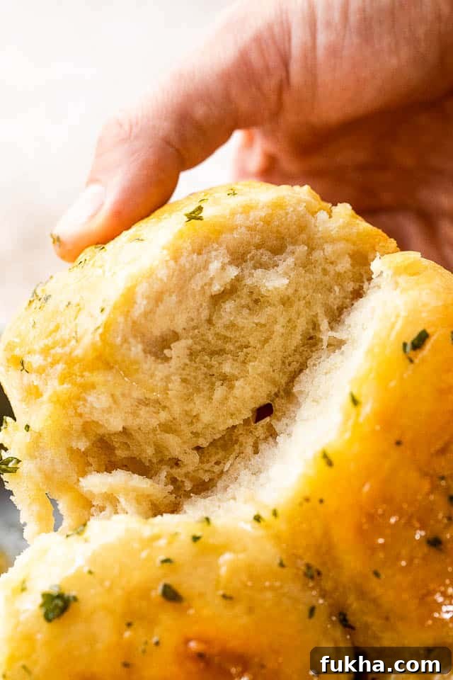 No-Knead Dinner Rolls: Soft, Fluffy Homemade Recipe 3 side shot of pulling apart dinner rolls