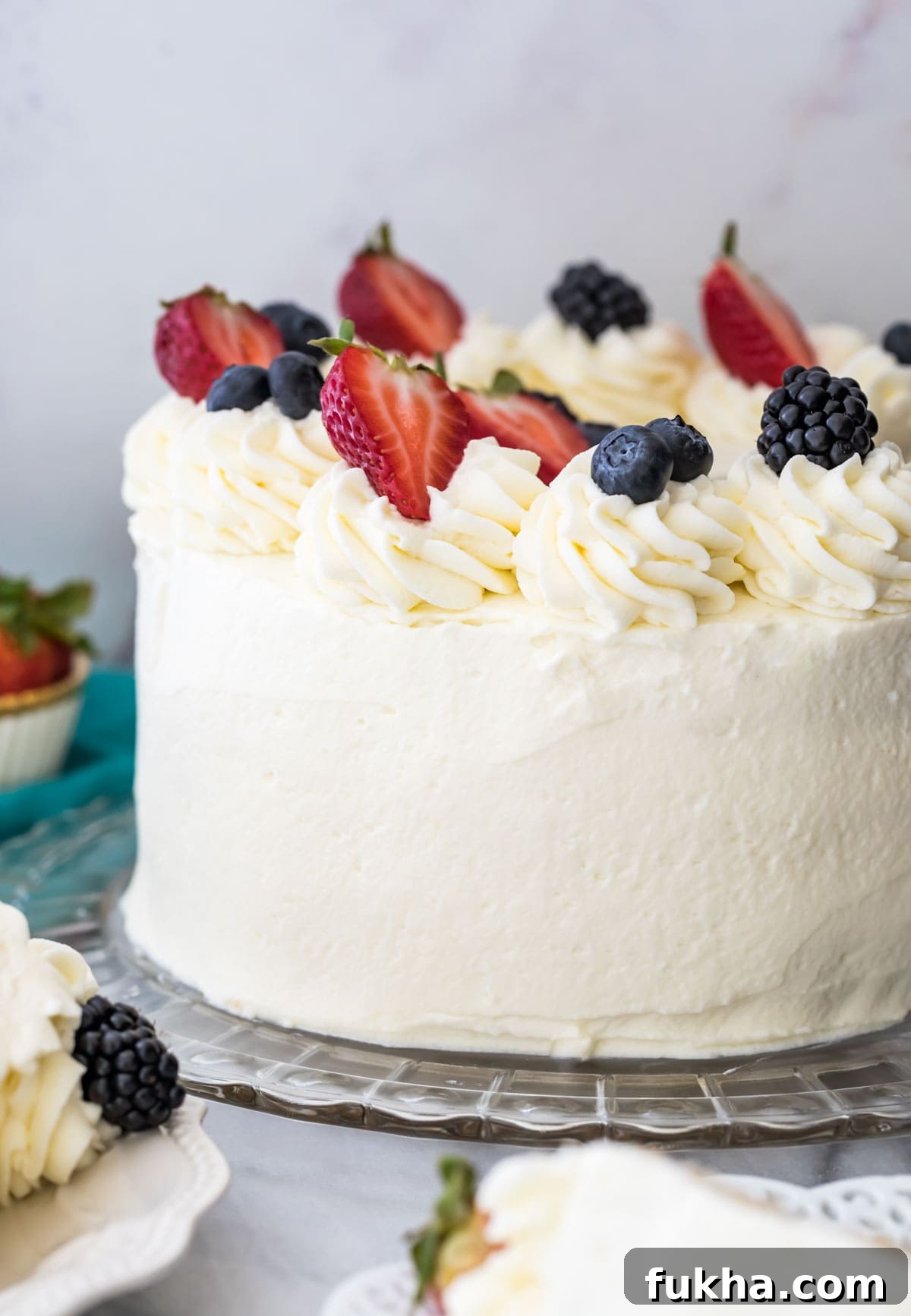 Decadent Chantilly Cream Cake Recipe 8 Chantilly cake on a glass platter, topped with fresh fruit