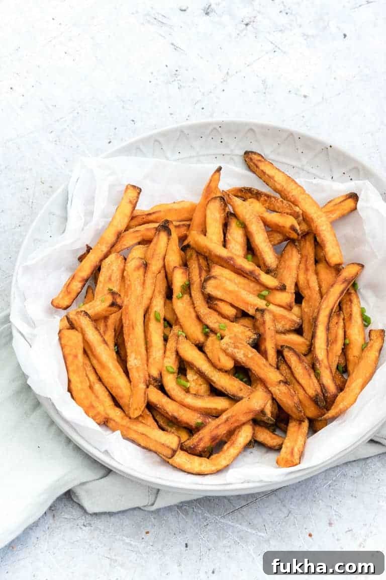 close up view of Air Fryer Sweet Potatoes served on a white plate
