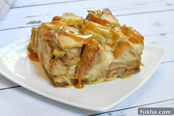 Caramel Apple Bagel Bread Pudding slice on a white plate
