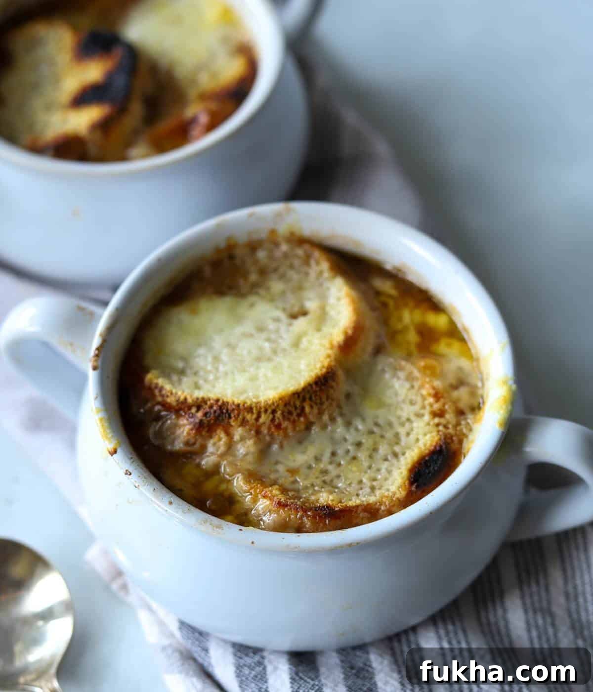 French onion soup in soup bowl with bread and cheese. 