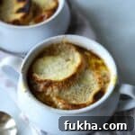 French onion soup in soup bowl with bread and cheese.