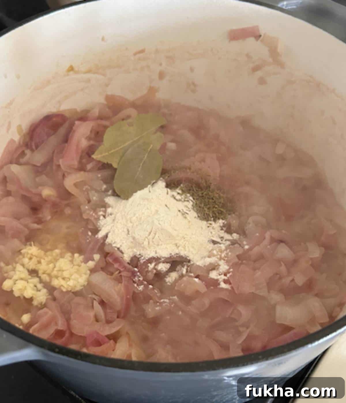 Onions with flour, bay leaf, and garlic.