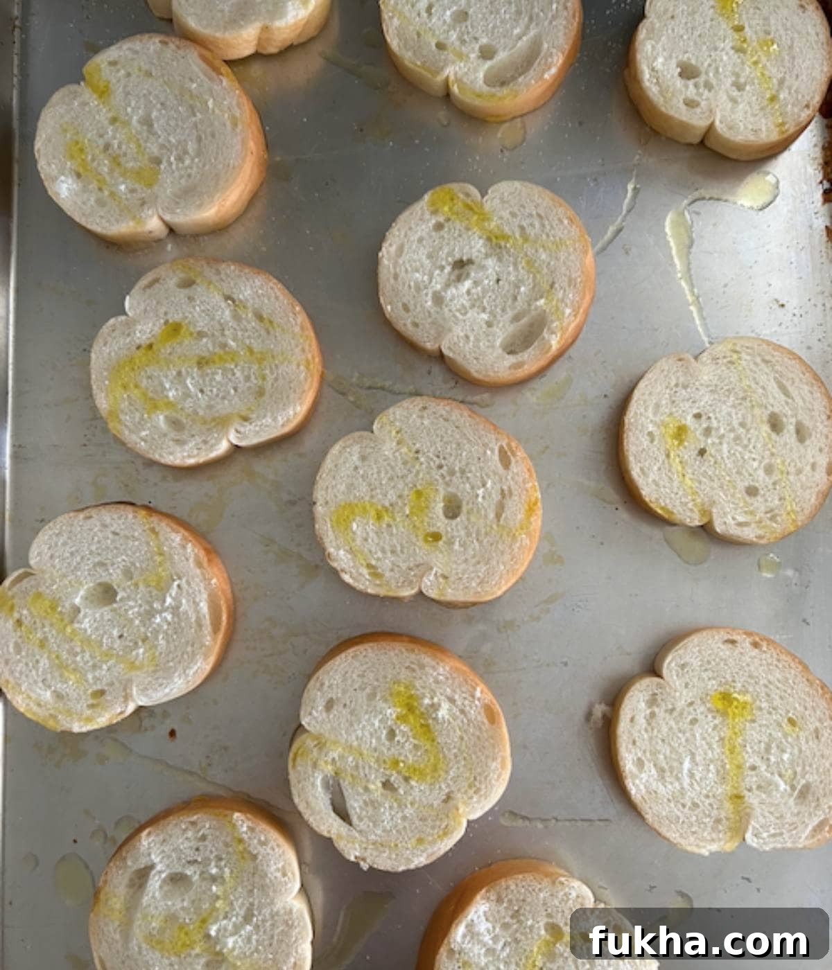 Sliced baguette on cutting board.