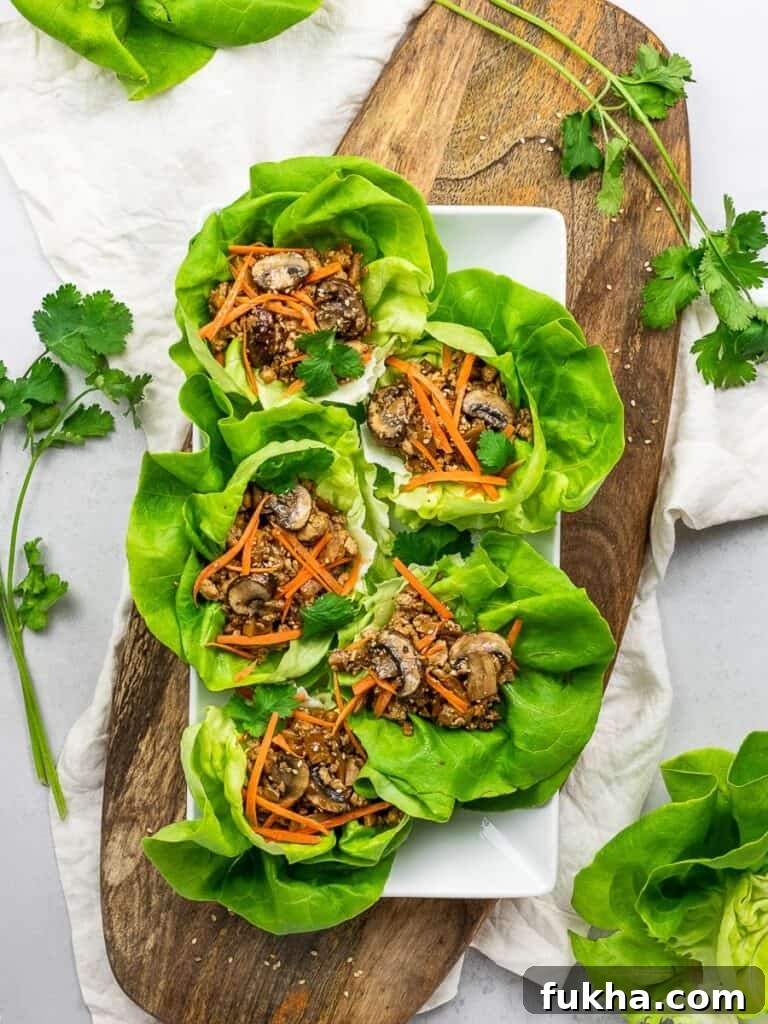 PF Chang's vegetarian lettuce wraps with tofu, mushrooms, carrots, and lettuce on a wooden board
