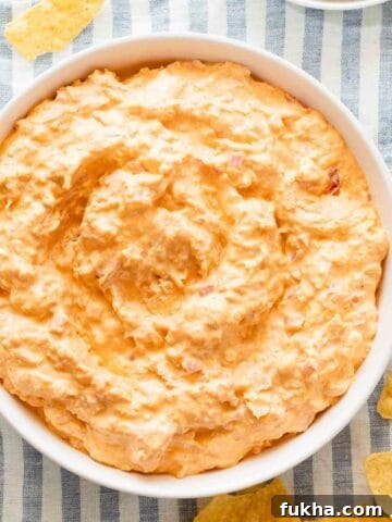 bowl of Greek yogurt buffalo chicken dip with chips on the side.