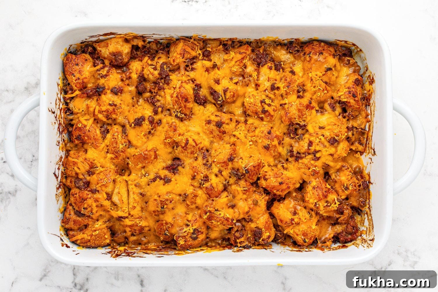 Sloppy Joe Bubble Up Casserole in a white ceramic casserole dish
