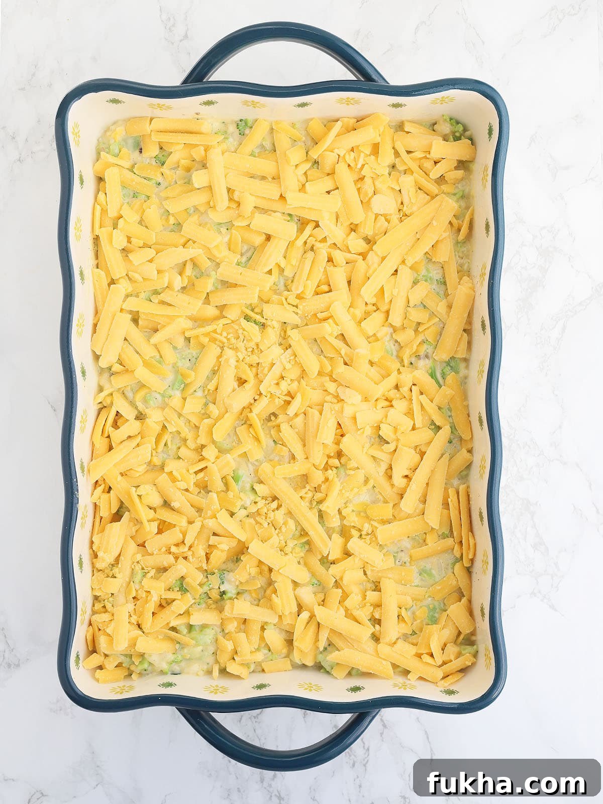 Creamy Broccoli Cheese Casserole 9 unbaked cheesy broccoli casserole topped with shredded cheese