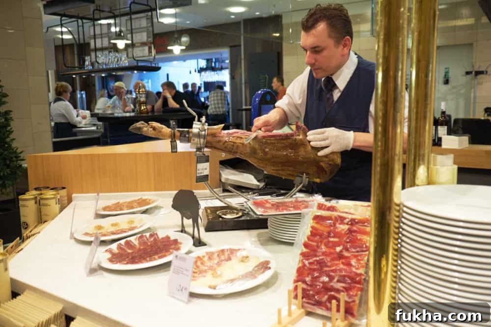 24-Hour Berlin Food Guide: What to Eat in a Day 14 A man slices Iberico ham at KaDaWe in Berlin.