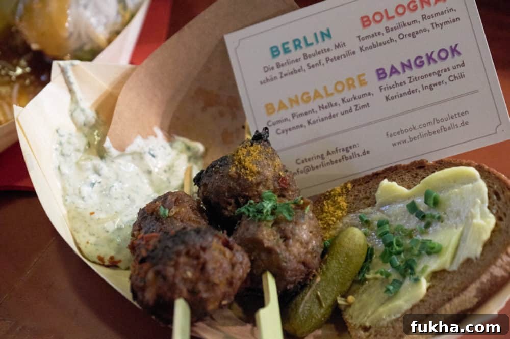 24-Hour Berlin Food Guide: What to Eat in a Day 5 Bouletten, traditional Berlin meatballs, in a small paper container at Markthalle Neun, Berlin, Germany.