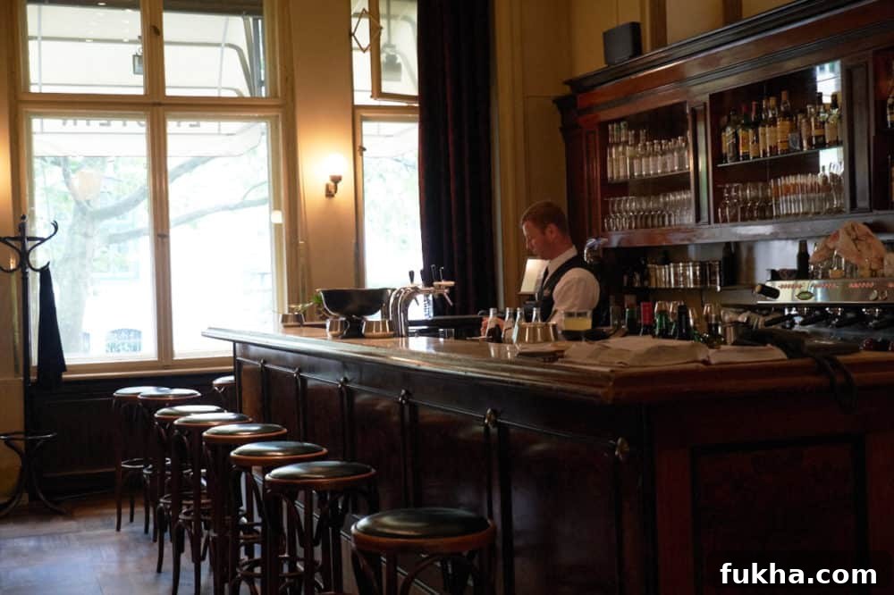 24-Hour Berlin Food Guide: What to Eat in a Day 7 A man behind the bar at a café.