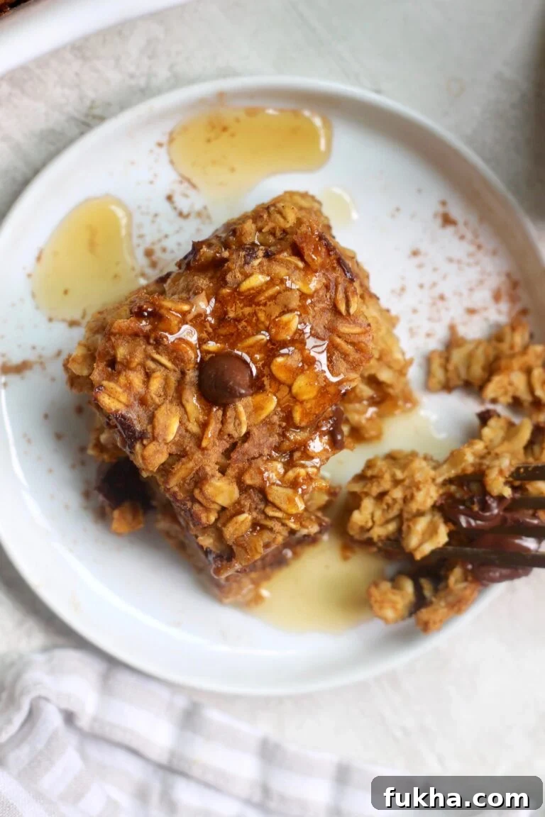 pumpkin oatmeal square on plate with maple syrup