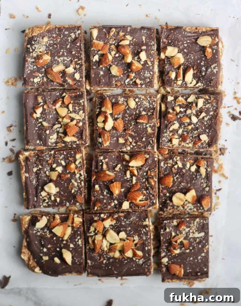 cut chocolate almond butter bars on parchment paper