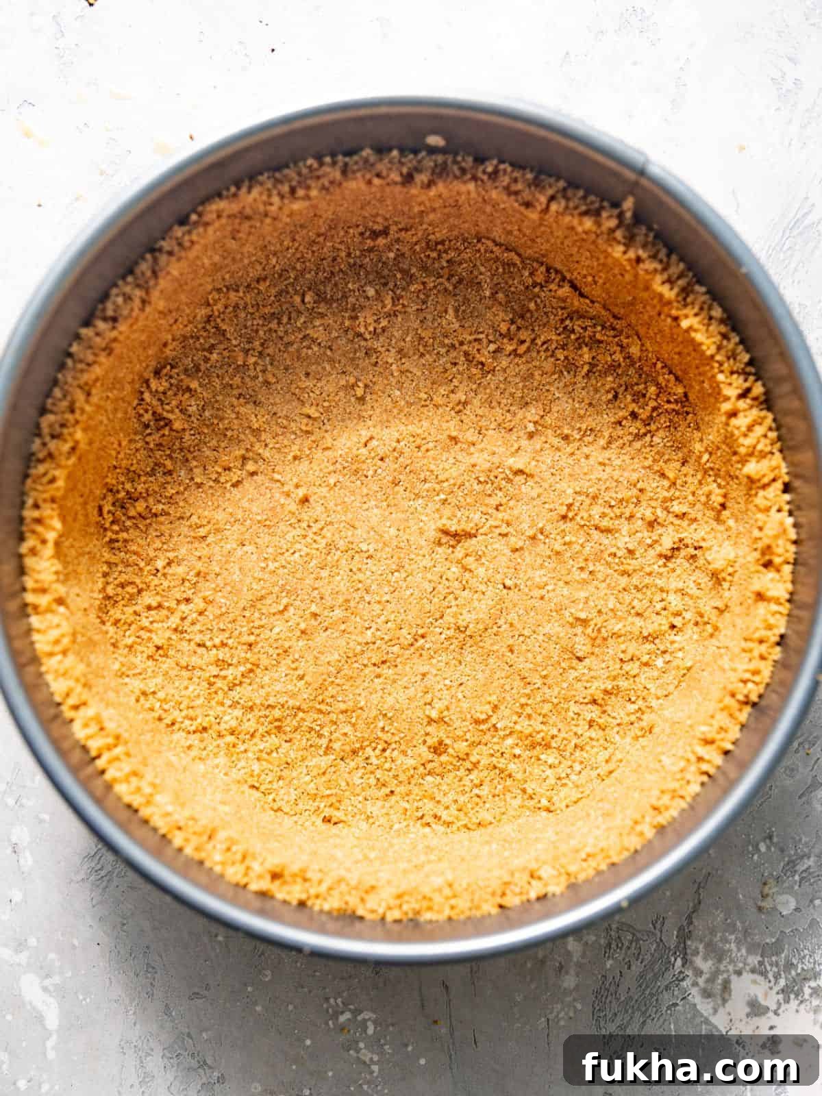 Creamy Pistachio Cheesecake Recipe 4 pistachio graham cracker crust in a springform pan.