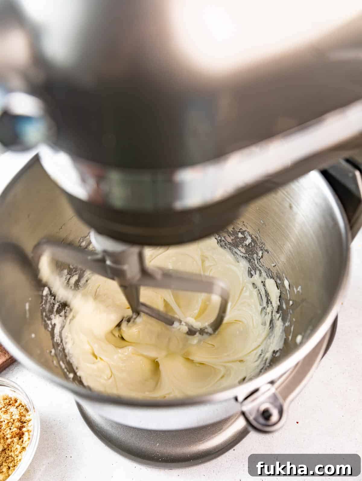 Creamy Pistachio Cheesecake Recipe 5 pistachio cheesecake batter in the bowl of a stand mixer.