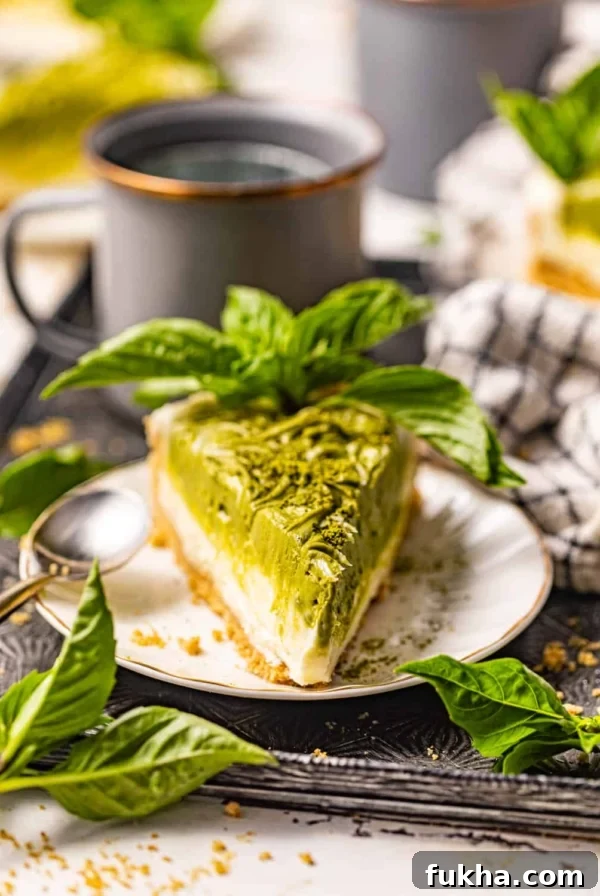 Creamy Pistachio Cheesecake Recipe 10 a slice of matcha cheesecake on a plate.