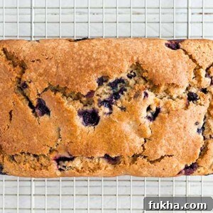 Overhead view of Blueberry Muffin Bread loaf on a wire rack