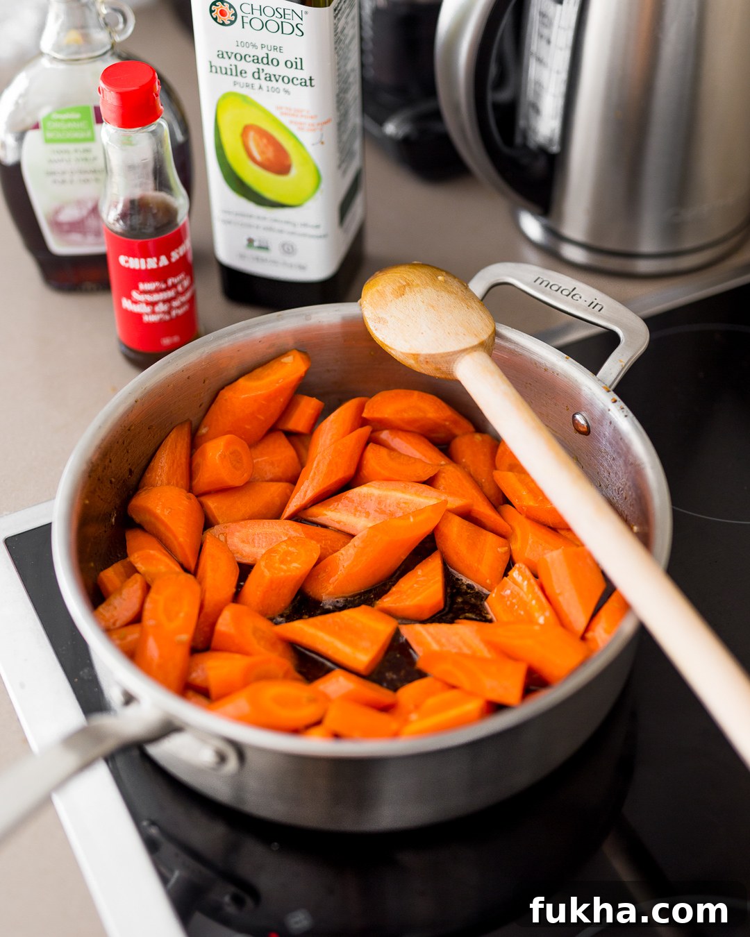 Carrots in maple sesame sauce cooking in pan