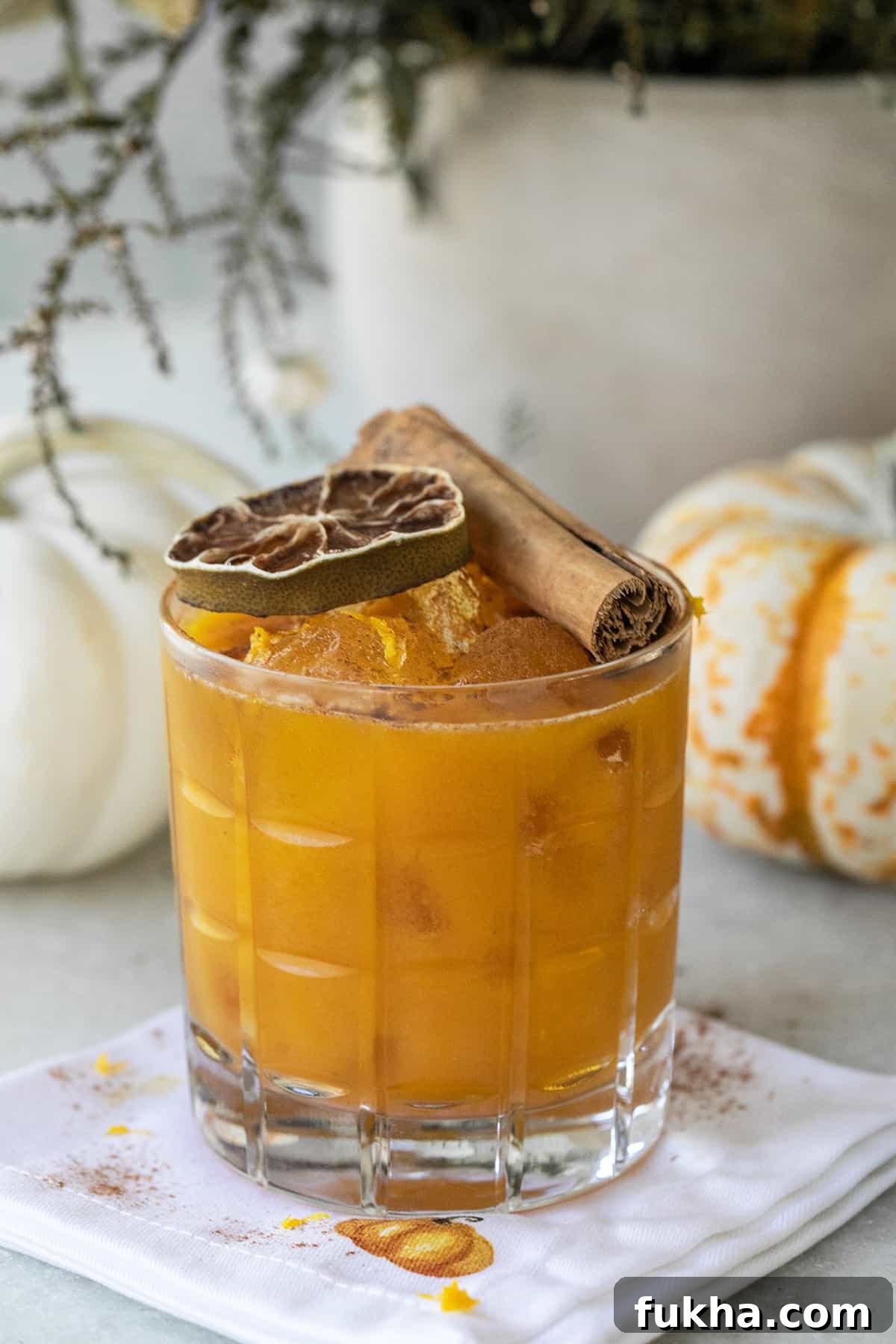 Margarita Recipes for Spring, Summer, Fall and Winter 9 Pumpkin spice margarita in a glass with a cinnamon stick and lime wheel.