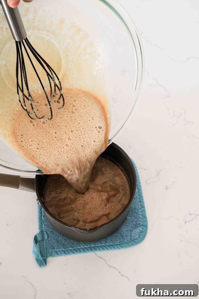 The chocolate custard is poured back into the pot to finish cooking over the stove.
