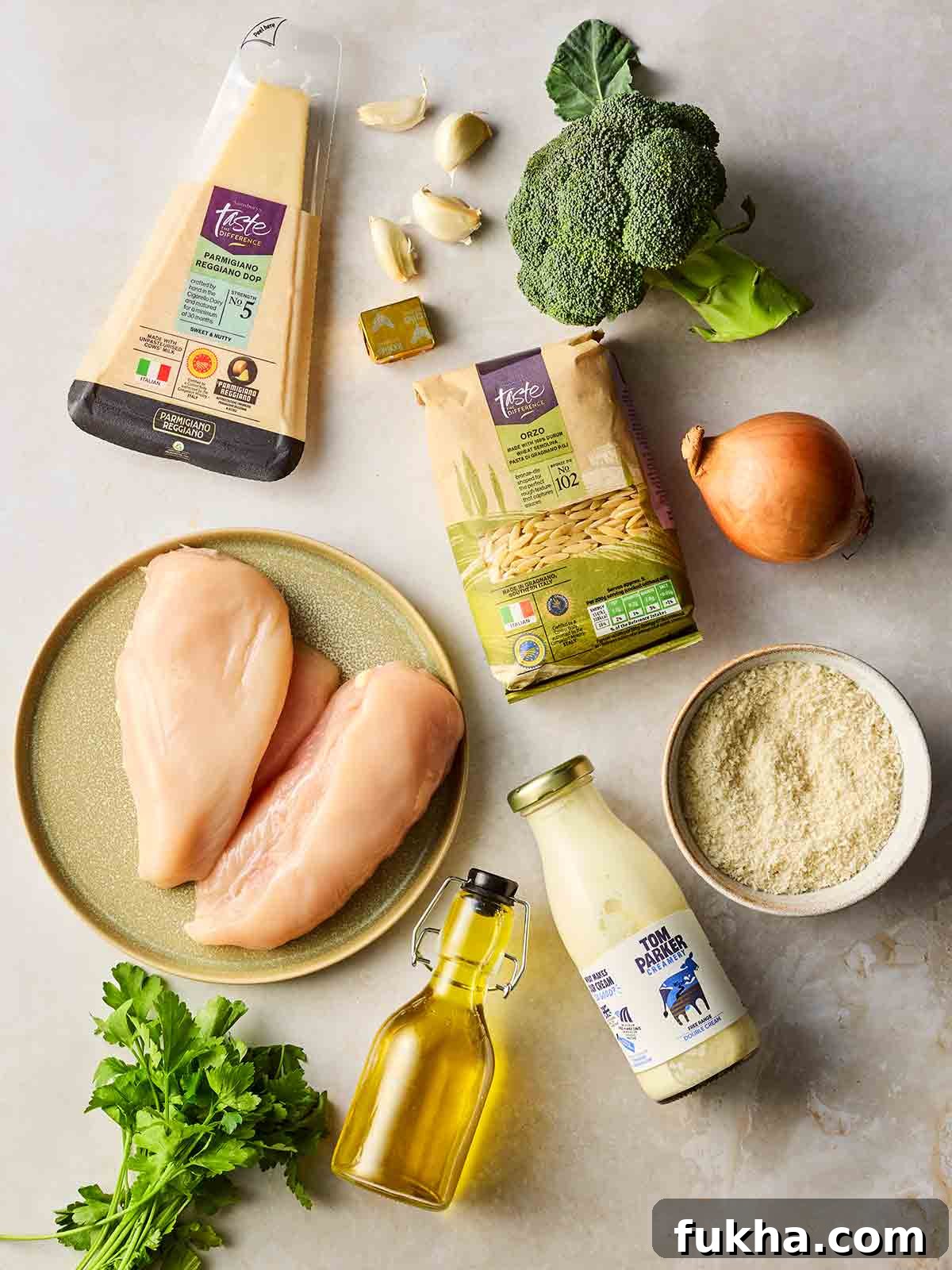 Dump-and-Bake Chicken Kyiv with Creamy Orzo 4 Chicken Kiev Pasta ingredients laid out on a white surface.