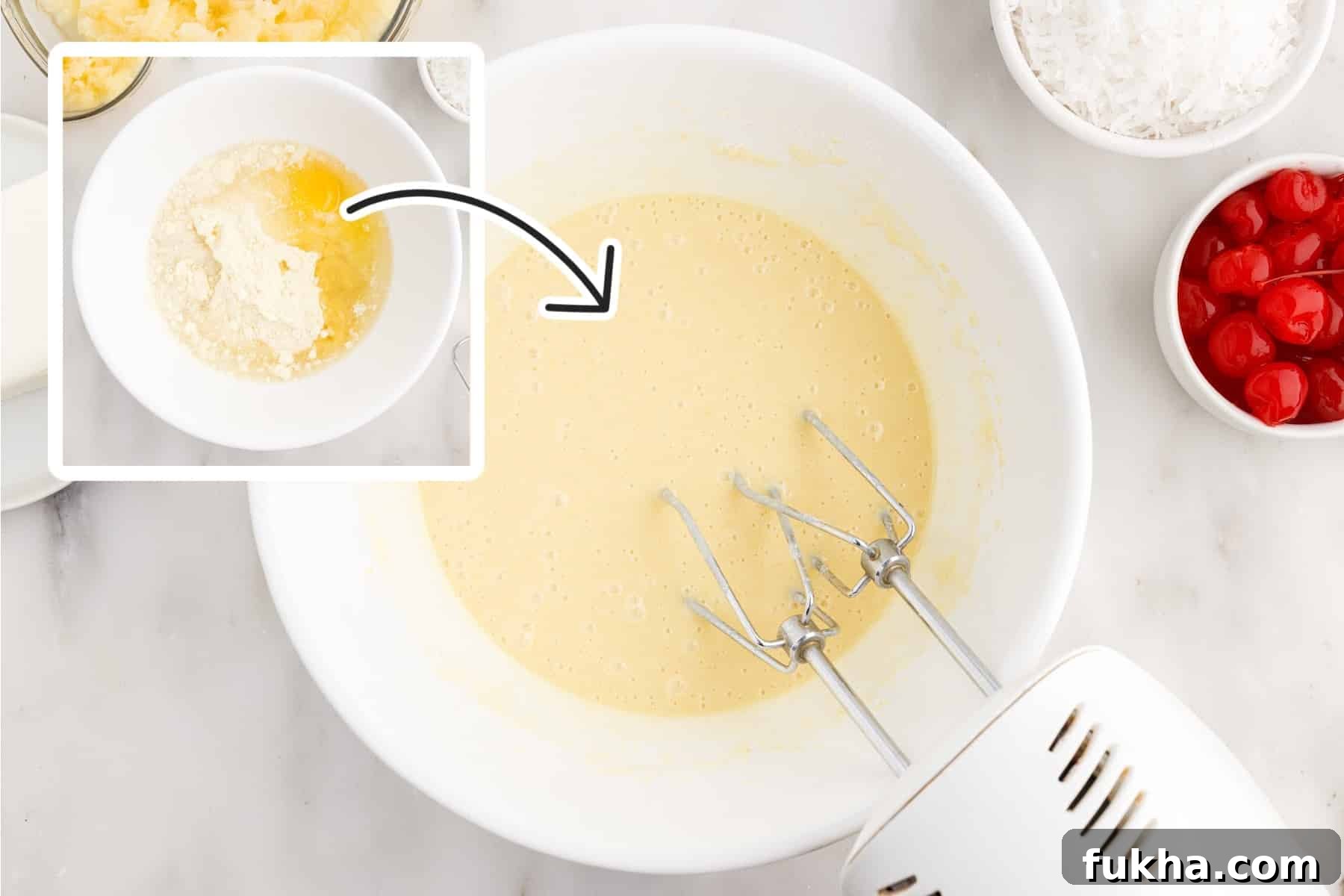 Cake mix, oil and water being mixed in a bowl.