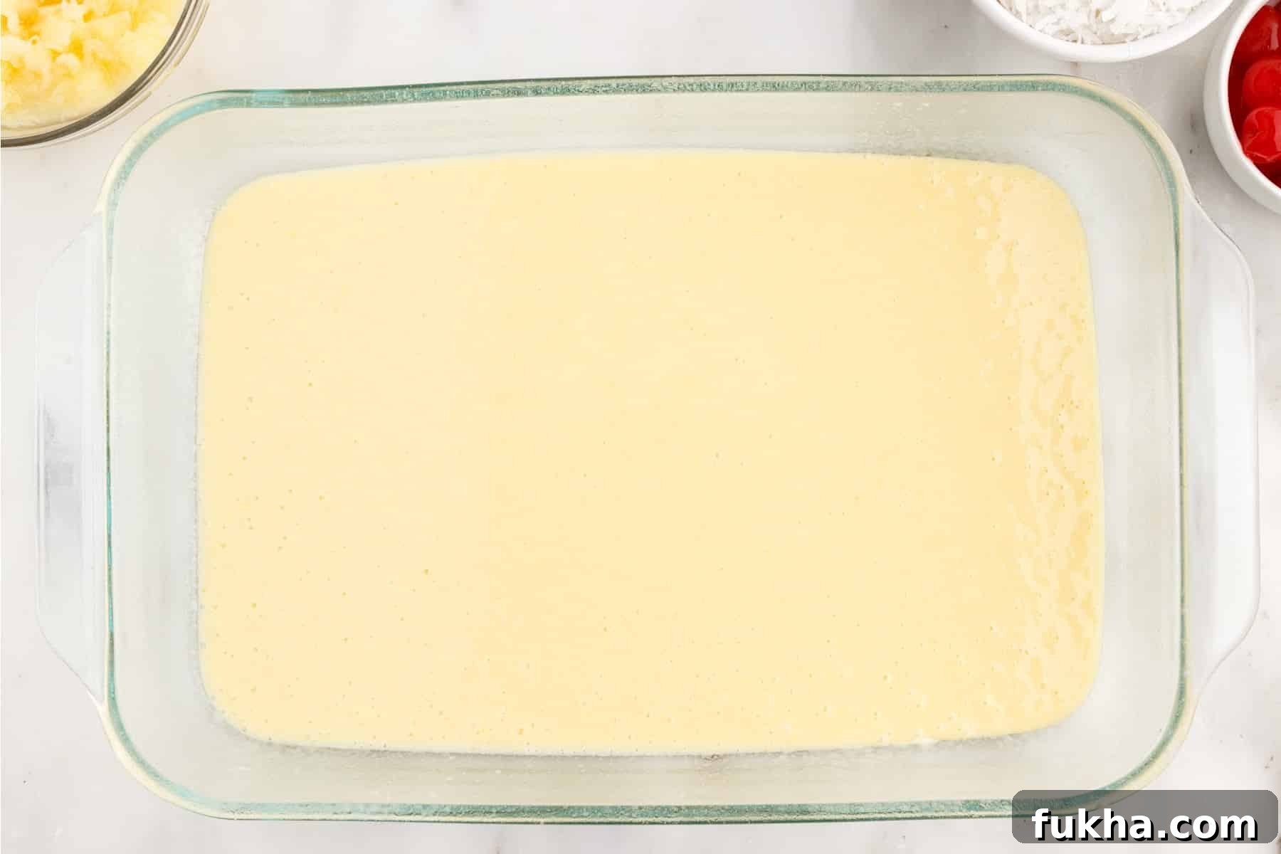 Cake batter poured into a 9x13 baking dish.