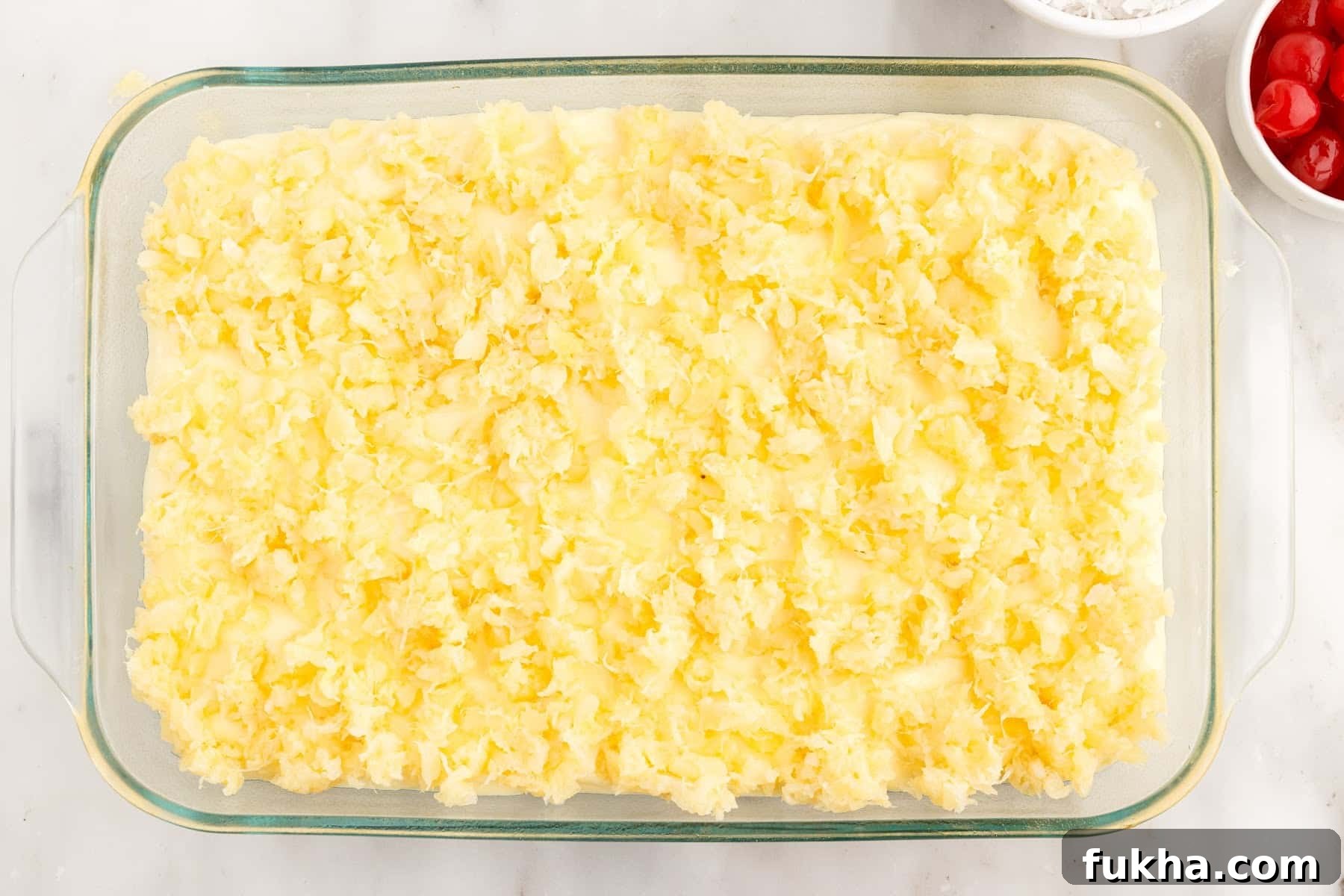 Drained crushed pineapple added on top of cake.