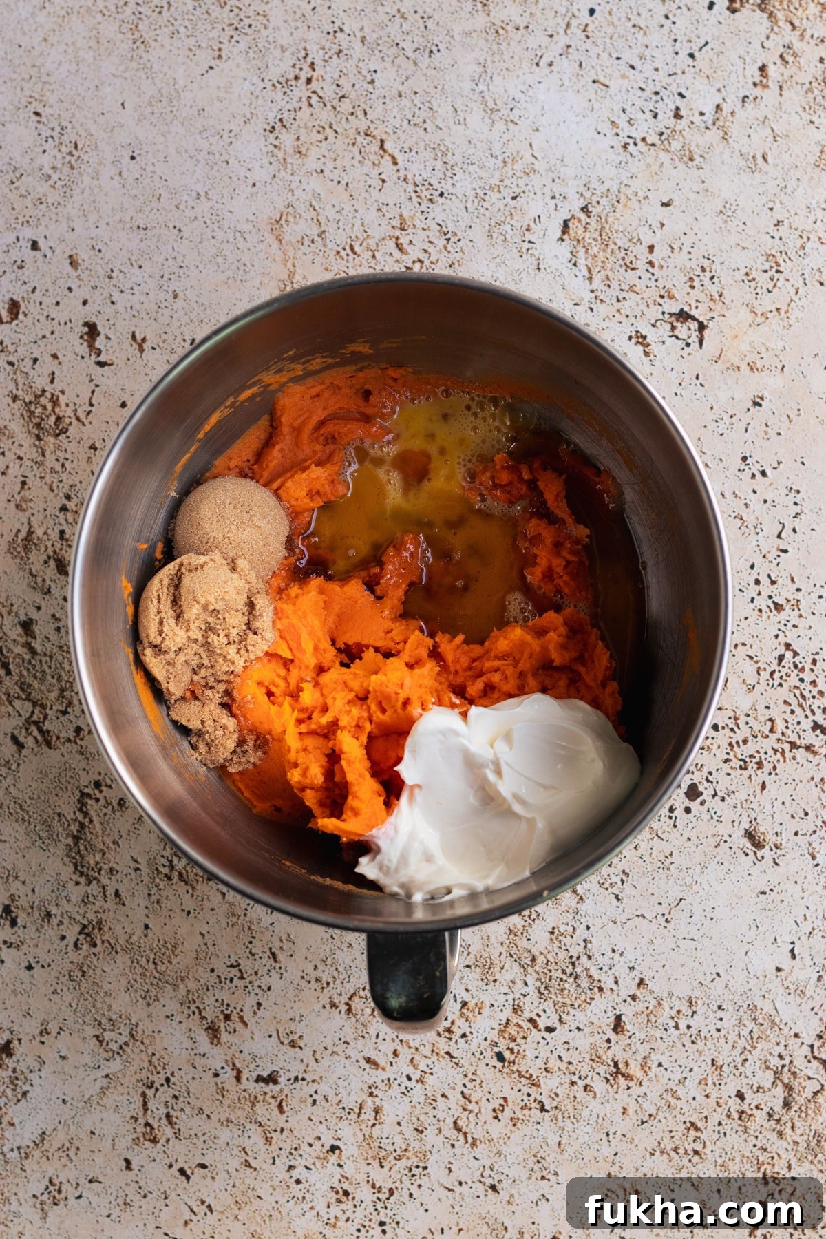 mashed sweet potatoes in a stainless steel bowl.