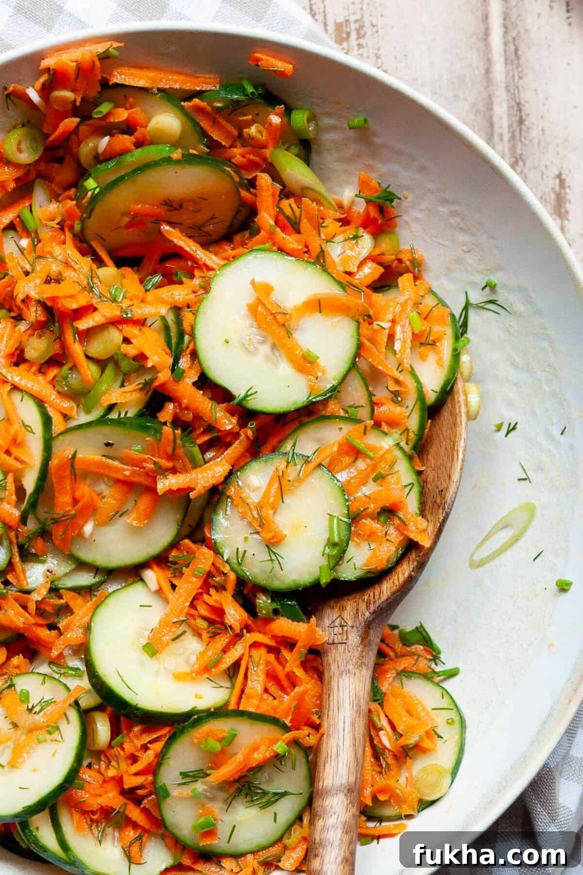Simple Italian carrot and cucumber salad tossed in a light apple cider vinaigrette with chives and green onion.