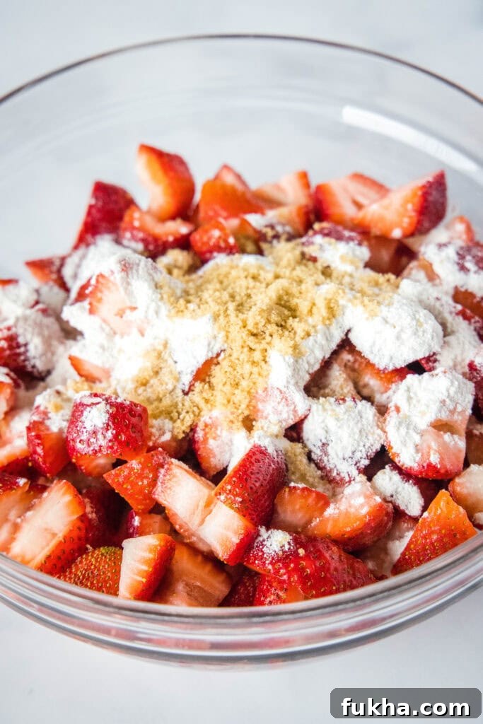 bowl of strawberries with flour and brown sugar on top