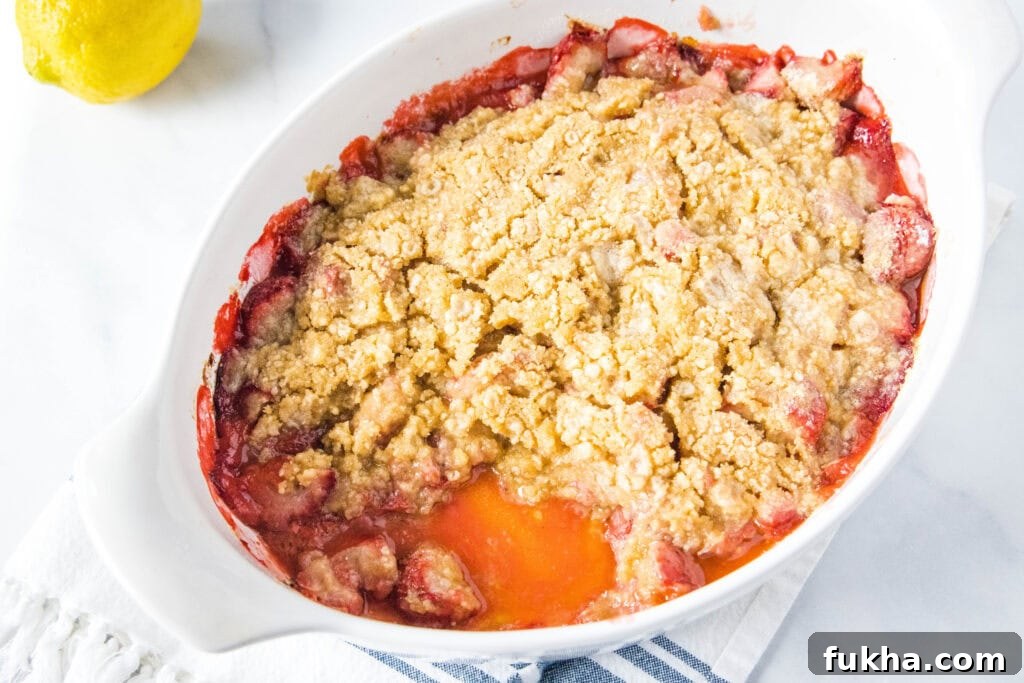 Strawberry Crumble - the perfect dessert for fresh strawberries! Juicy strawberries with a buttery brown sugar crumble topping. Serve with a scoop of ice cream for a decadent treat!