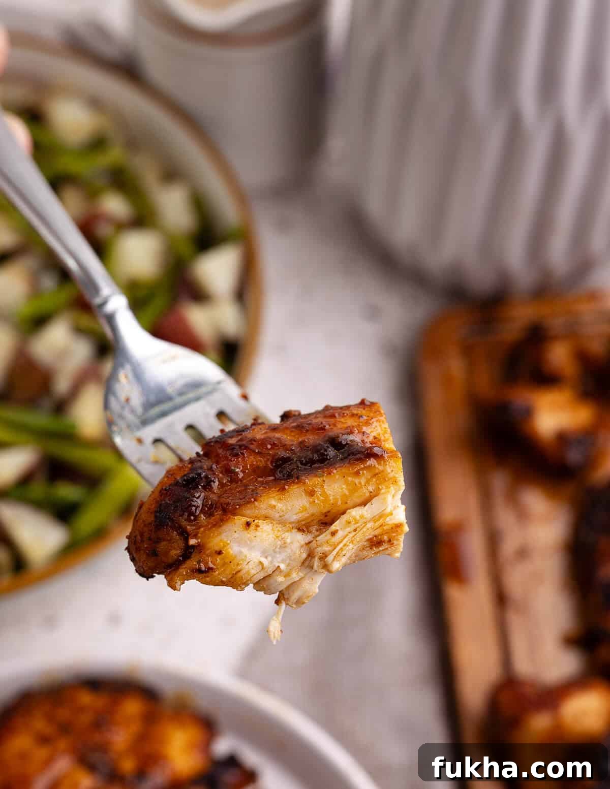a bite of chicken on a fork. 