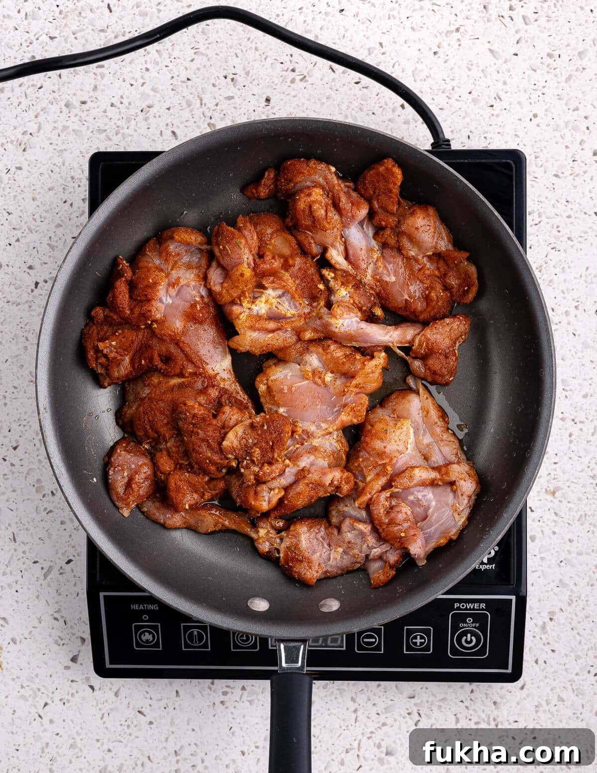 seasoned chicken thighs in a skillet 