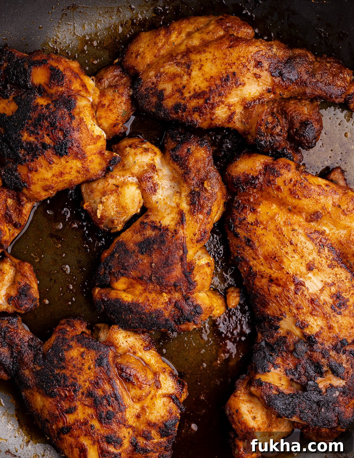 caramelized chicken thighs in a skillet. 